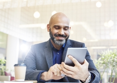 Modern businessman using his tablet in an office